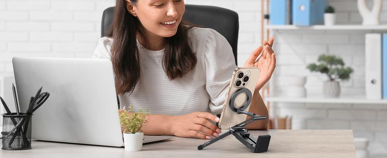 Woman using magnetic stand at desk Woman using magnetic stand at desk