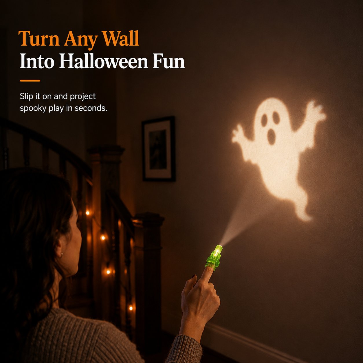 Green finger projector casting a Halloween ghost image onto an indoor wall