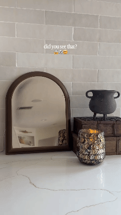 Halloween ghost mirror revealing a glowing ghost holding a candle