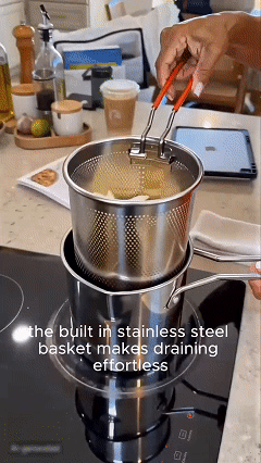 Mini fryer basket being lifted to drain excess oil